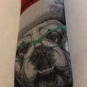 Dog with red hat on black tie , white snowflakes